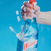 Cleaning smudges on glass with Windex